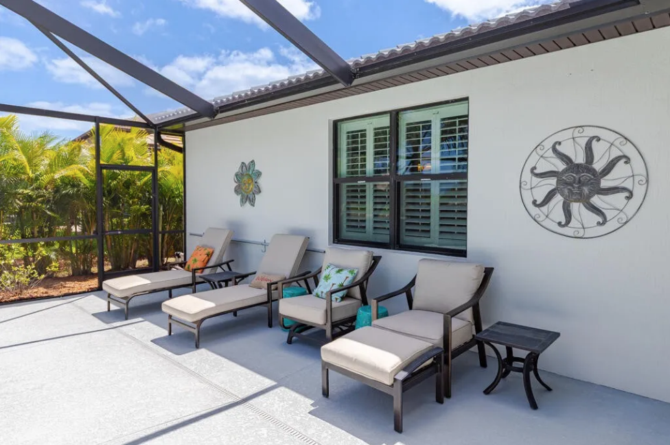 Screened pool enclosure with waterfall feature — Veranda Gardens pool home Port St. Lucie FL