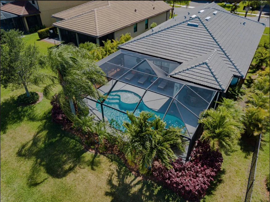 Backyard lake view from pool deck at 348 SE Courances Drive, Port St. Lucie FL