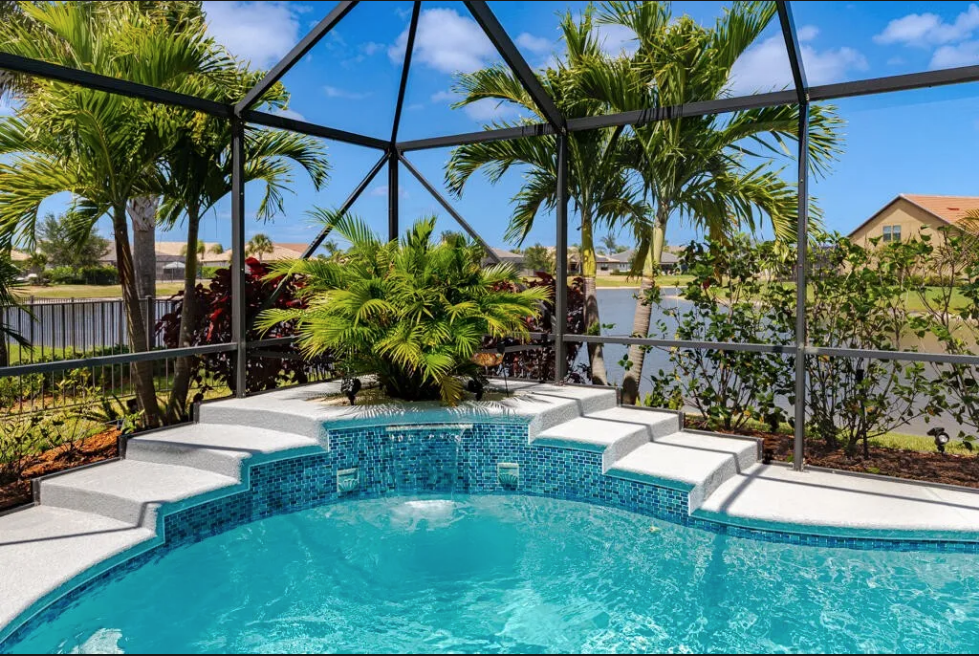 Pool waterfall and lake view at 348 SE Courances Drive, Port St. Lucie FL 34984